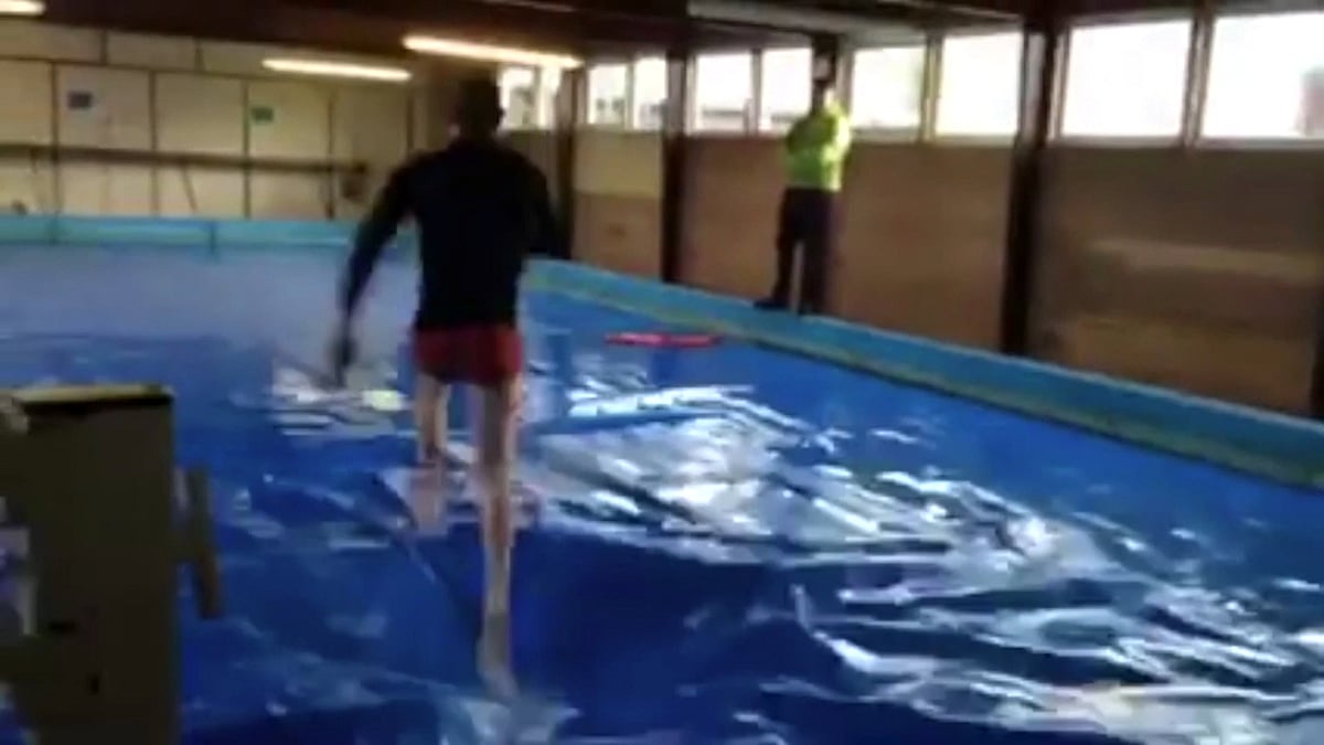 Scott Crosby, sprinting across a swimming pool without sinking. (Photo: AP/Caters TV screengrab)