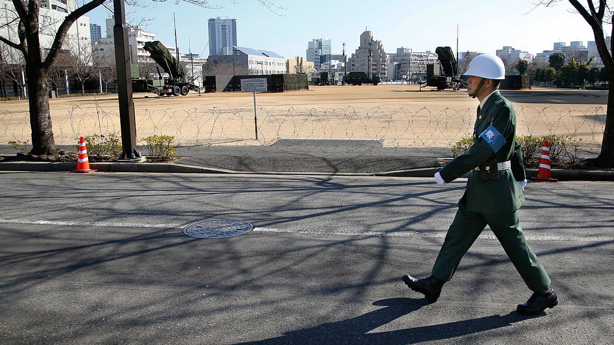 A Japan Self-Defense Force member walks past a PAC-3 Patriot missile unit deployed for North Korea’s rocket launch at the Defense Ministry in Tokyo. (Photo: AP)