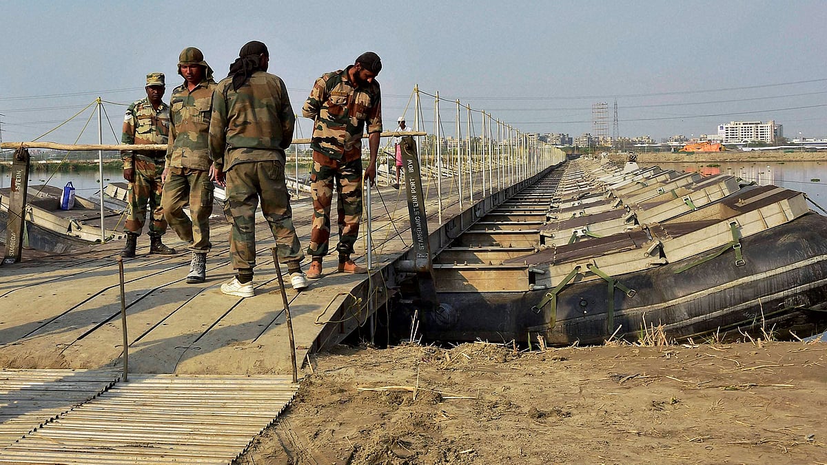 Army personnel construct temporary bridges over Yamuna river for the three-day World Peace Festival organised by spiritual guru Sri Sri Ravi Shankar in New Delhi on Tuesday. (Photo: PTI)