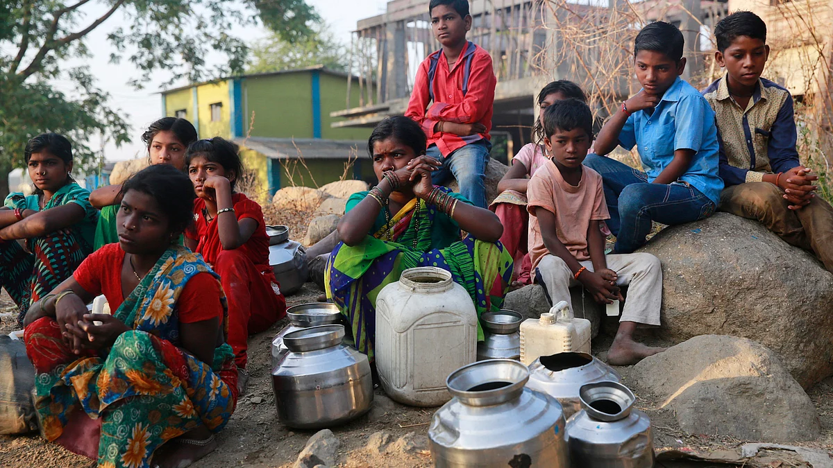 People wait to fill their vessels with water at a communal tap in Kukse Borivali, 85 kilometres (53 miles) north-east of Mumbai. (Photo: AP)