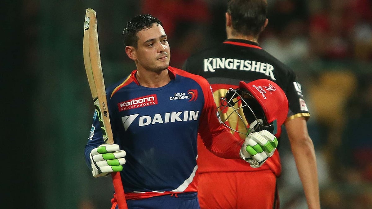 Quinton de Kock raises his bat after scoring a century against RCB. (Photo: BCCI)