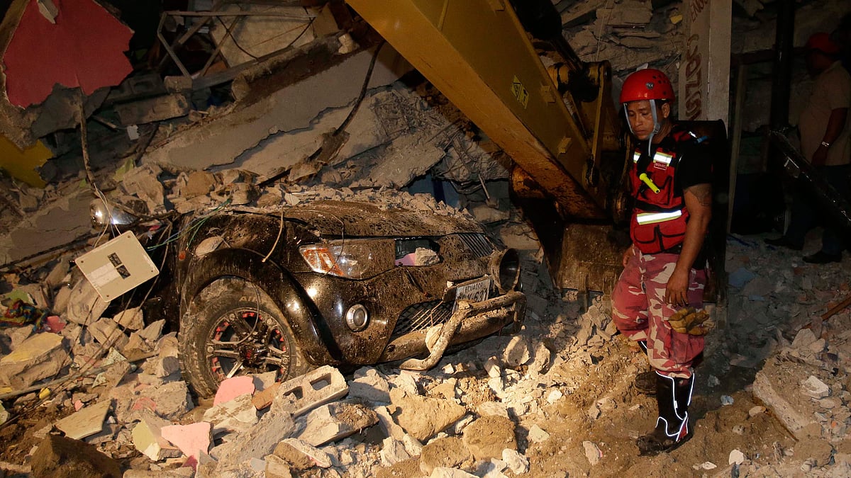 A rescue worker searches in the rubble of a destroyed house in the Pacific coastal town of Pedernales, Ecuador on Sunday. (Photo: AP)