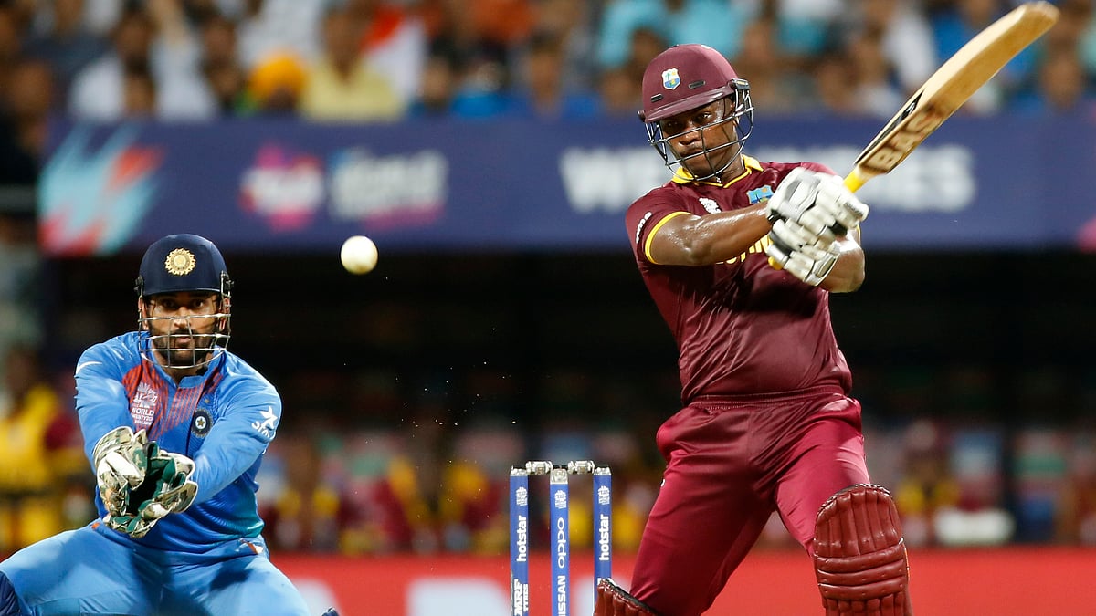 Johnson Charles and MS Dhoni in action during the World T20 semi-final between India and West Indies at Mumbai. (Photo: AP)