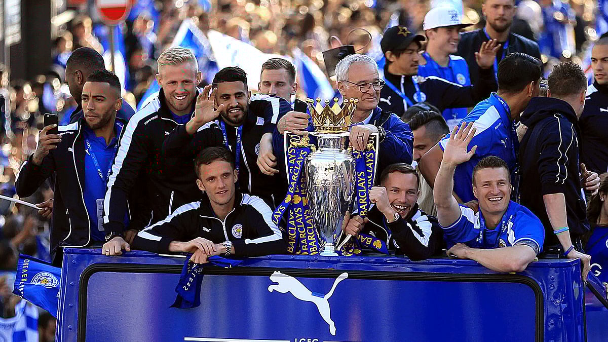 Leicester City players and staff celebrate with the trophy after winning the English Premier League during an open top bus parade through Leicester city centre. (Photo: AP)