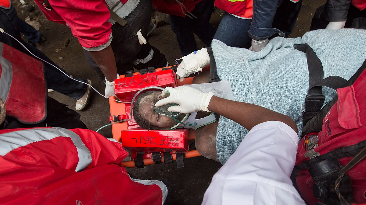 Elizabeth Night Odhiambo is carried away on a stretcher by medics as she is rescued after being trapped for six days under the rubble of a collapsed building in  Nairobi, Kenya. (Photo: AP)