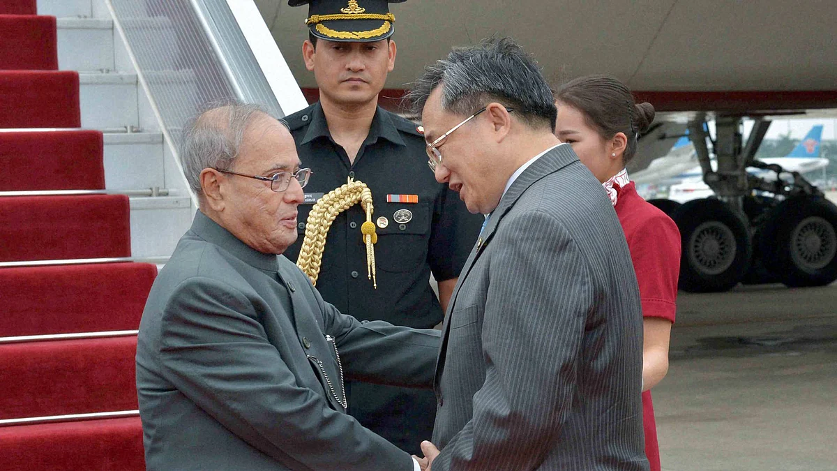 President Pranab Mukherjee is received by  China’s Foreign Affairs Vice Minister Liu Zhenmin upon his arrival at Guangzhou in China. (Photo: PTI)