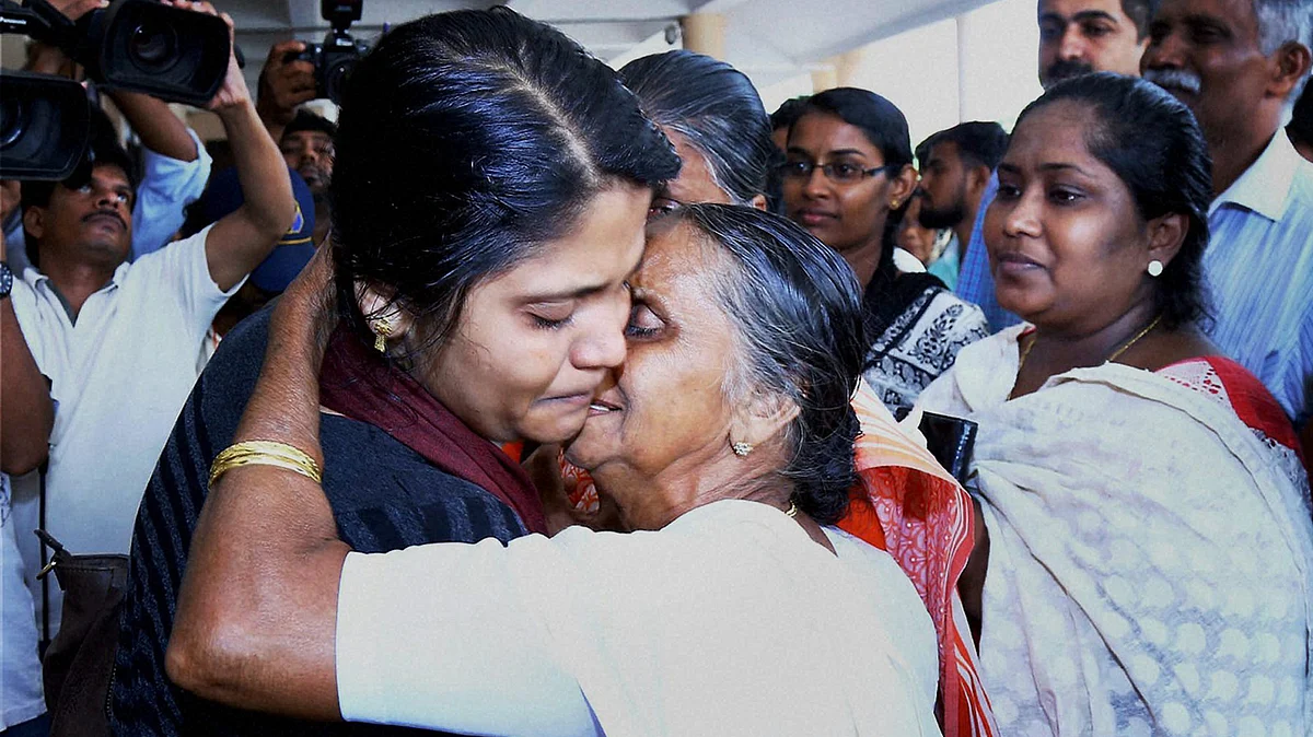 The first batch of 16 Keralites, evacuated from Libya, uniting with their families and relatives on their arrival at Kochi International Airport on Thursday. (Photo: PTI)