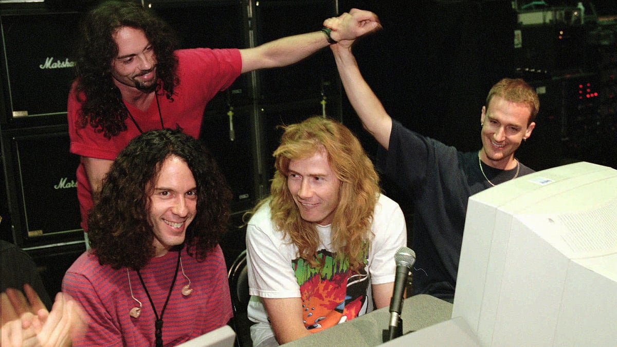 File photo of former drummer Nick Menza giving a high-five to Megadeth bassist David Ellefson with Marty Friedman (left) and Dave Mustain (right). (Photo: AP)