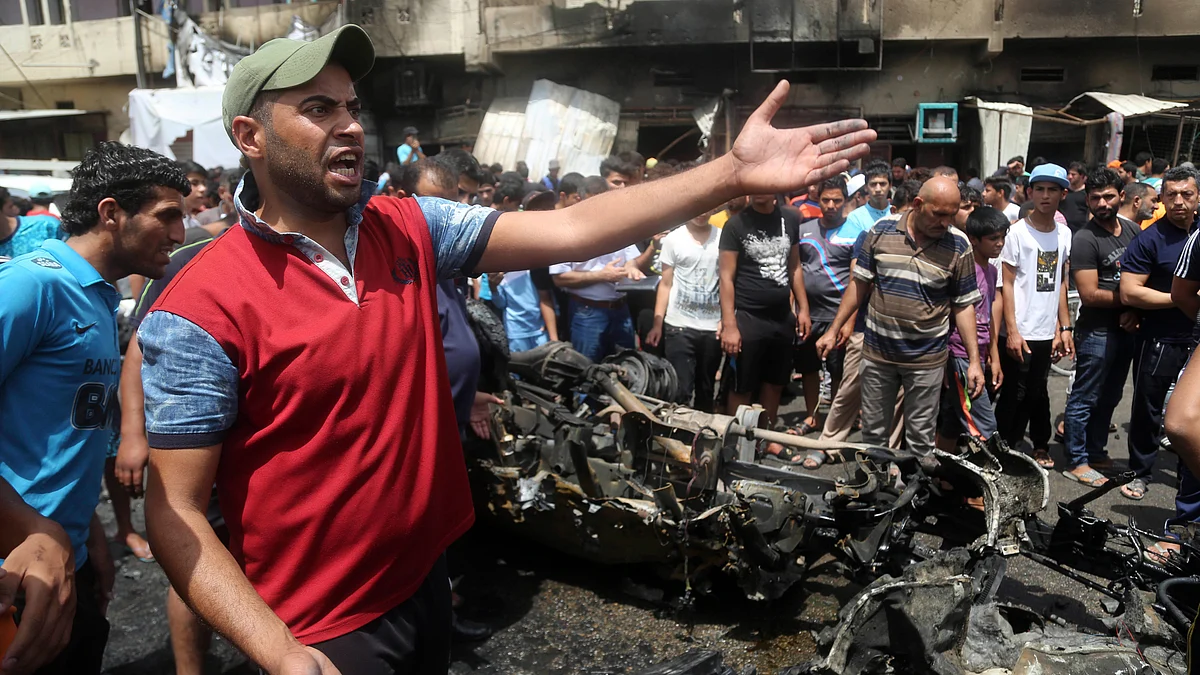 Citizens gather at the scene after a car bomb exploded at a crowded outdoor market in Baghdad, Iraq, on 11 May. (Photo: AP)