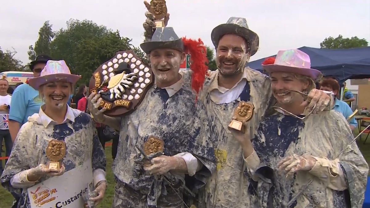 Winning team ‘The Custardeers’ with the World Custard Pie Trophy on Saturday. (Photo: AP/SNTV screengrab)