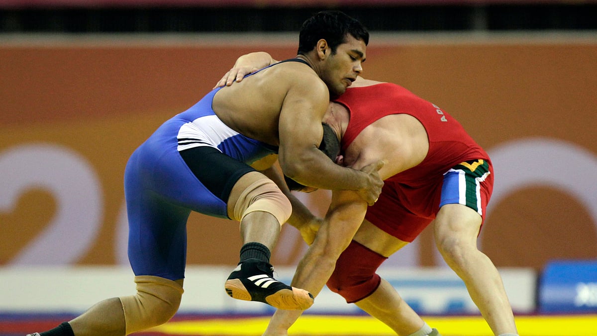 India’s Narsingh Pancham Yadav (in blue) challenges South Africa’s Richard Brian Addinall during their 74kg men’s freestyle wrestling match at the Commonwealth Games in New Delhi in 2010. (Photo: Reuters)