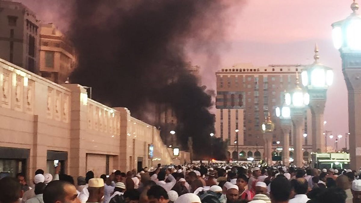 People stand by an explosion site in Medina, Saudi Arabia. (Photo: AP)