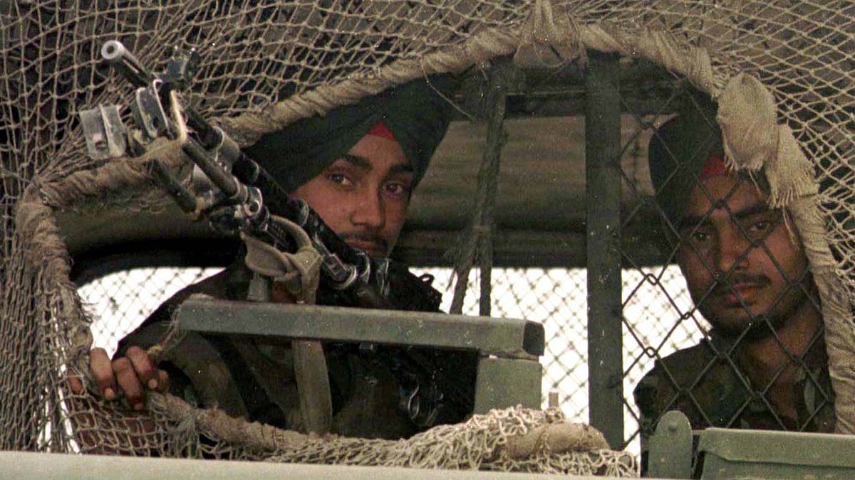 

Indian army officers look out from their vehicle covered with camouflage netting near Drass in the Kargil region of Kashmir on 26 May.