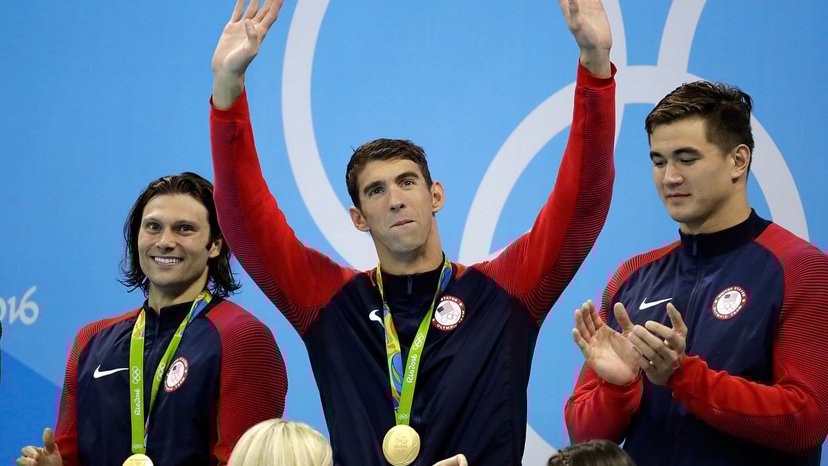  United States’ Michael Phelps waves as teammates Cody Miller, left, and Nathan Adrian look on during the medal ceremony for the men’s 4 x 100-meter medley relay final during the swimming competitions at the 2016 Summer Olympics. (Photo: AP)