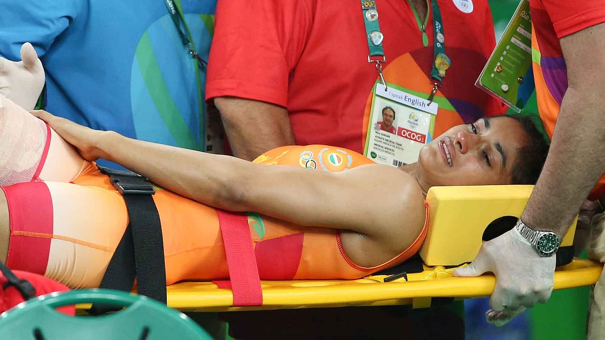 Vinesh Phogat is stretchered off after injuring her knee during the quarterfinal bout. (Photo: Reuters)
