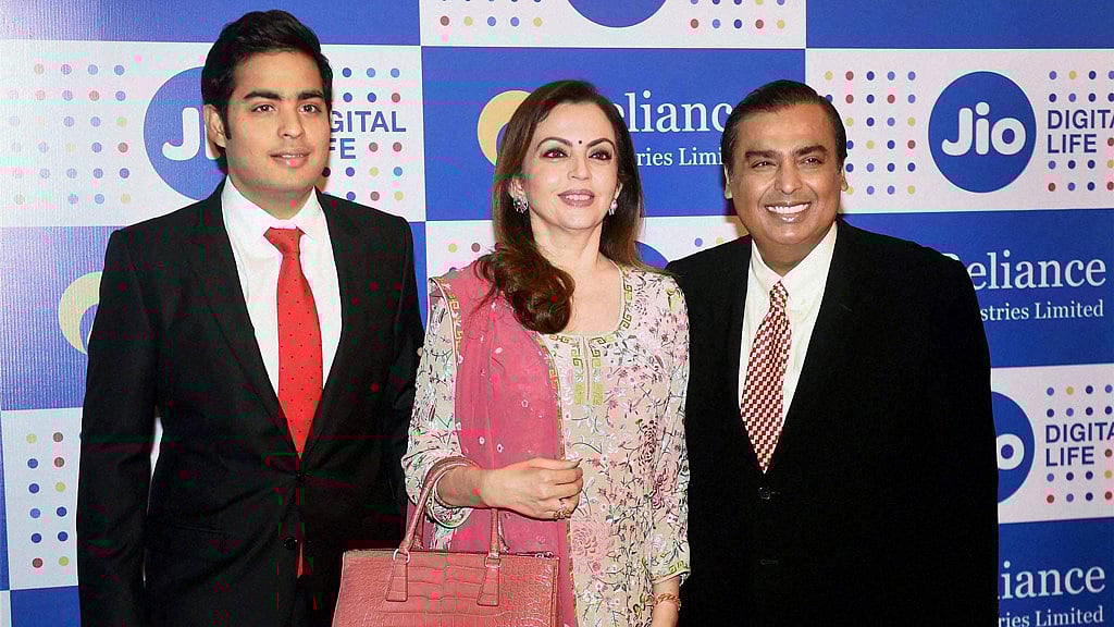  Mukesh Ambani, Chairman, Reliance Industries Ltd. with his wife Nita Ambani and son Akash Ambani arrives for the company’s annual general meeting in Mumbai on Thursday. (Photo Courtesy: PTI)&nbsp;