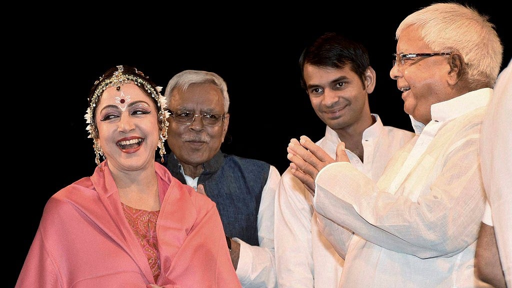 RJD Chief Lalu Prasad Yadav and Hema Malini caught candidly during the Diwali function in Patna. (Photo: PTI)