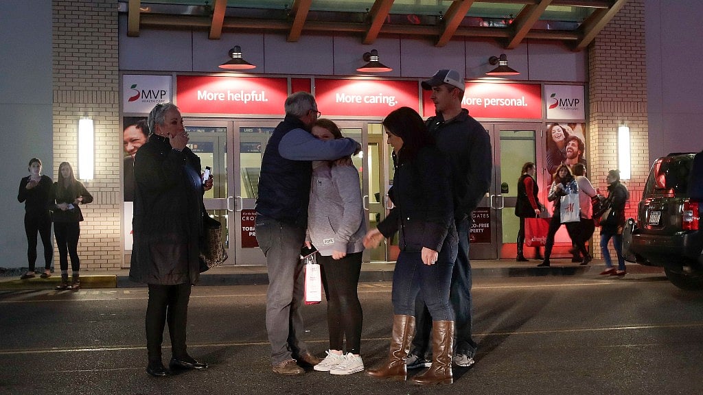 People embrace in New York, after reports of gunfire inside Crossgates Mall. (Photo: AP)
