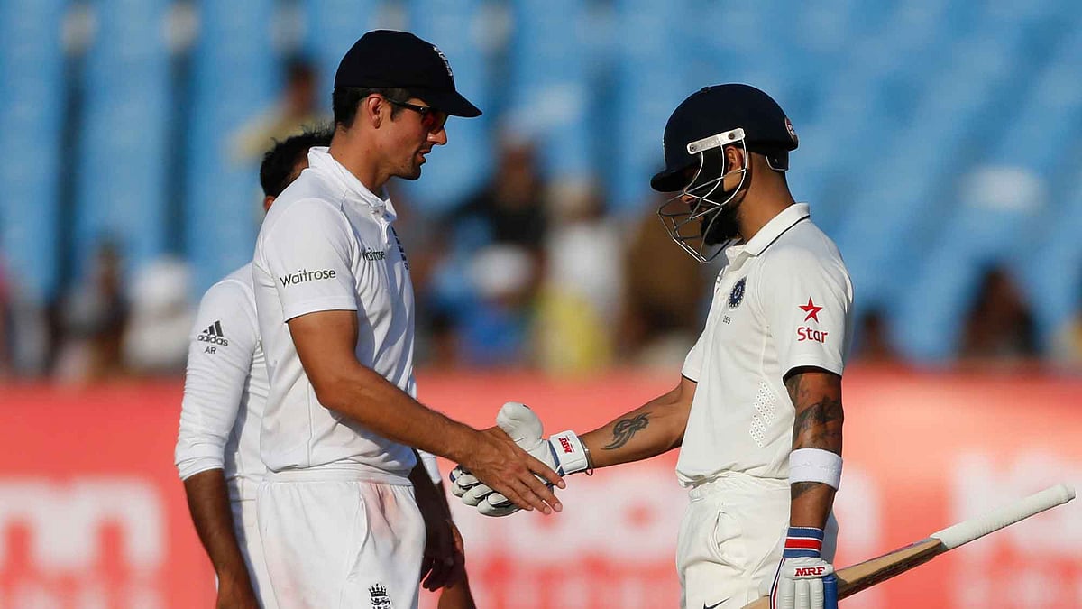 Alastair Cook and Virat Kohli shake hands at stumps on Day 5 of the Rajkot Test. (Photo: AP)