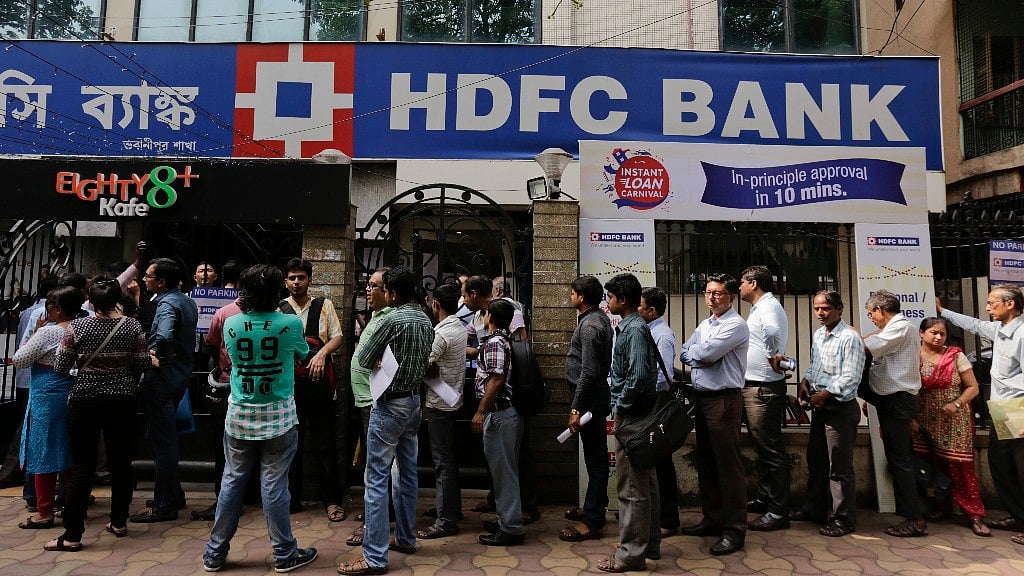 People queue outside HDFC bank. 