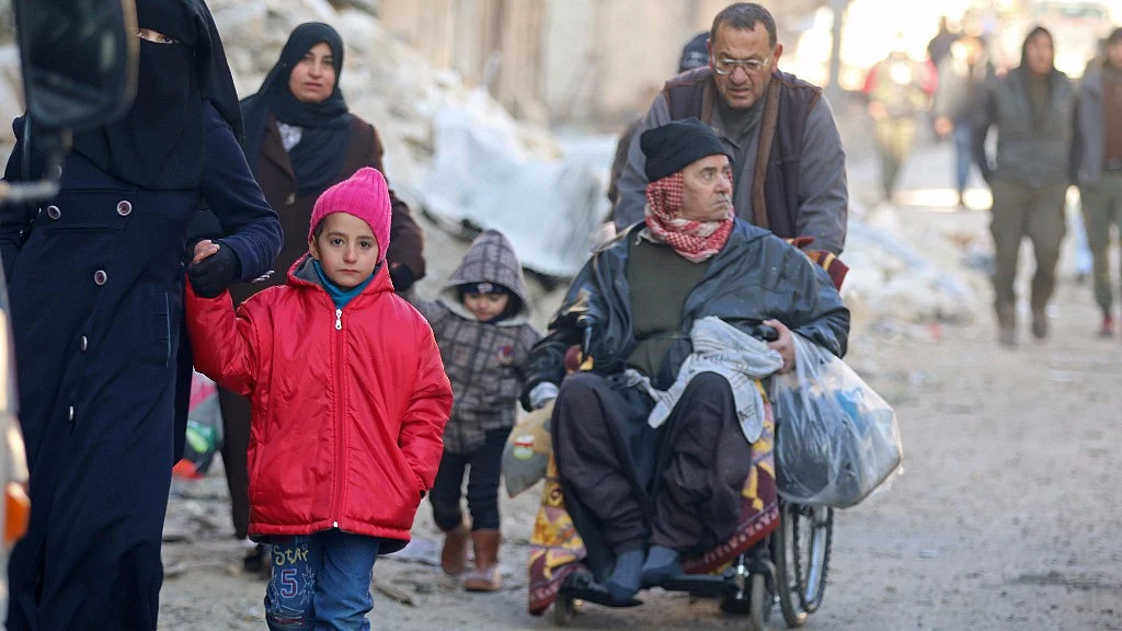 People walk as they gather to be evacuated from a rebel-held sector of eastern Aleppo on 15 December. (Photo: Reuters)