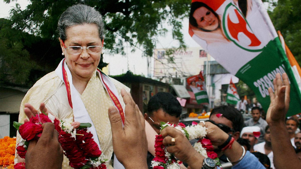 Congress Party President Sonia Gandhi receiving garlands during a road show in Varanasi in August 2016. (Photo: PTI)