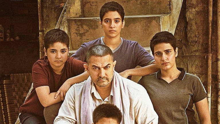 Aamir Khan and the  <i>Dangal </i>girls on the poster of the film.&nbsp;