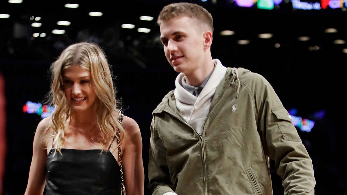 Genie Bouchard, walks the court with her blind date, John Goehrke, right, during the first half of an NBA basketball game between the Brooklyn Nets and the Milwaukee Bucks. (Photo: AP)