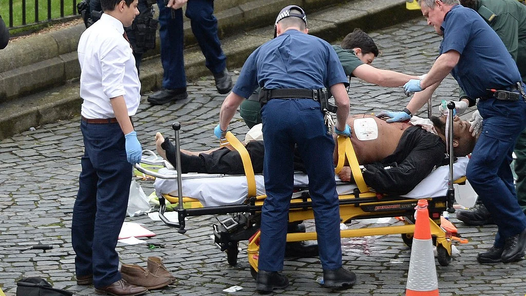 In this 22 March 2017 file photo the attacker, Khalid Masood, is treated by emergency services outside the Houses of Parliament London. (Photo: AP)