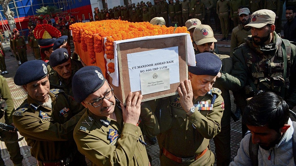 DGP and IGP of Jammu and Kashmir Police along with senior officers carry the casket of constable Manzoor Ahmad who was killed during an encounter at Tral. (Photo Courtesy: PTI)