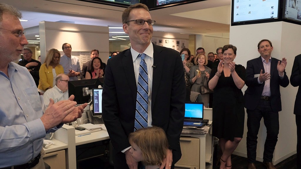 David Fahrenthold (center) reacts upon learning that he won the Pulitzer Prize for National Reporting, for dogged reporting of Donald Trump’s philanthropy. (Photo: AP)