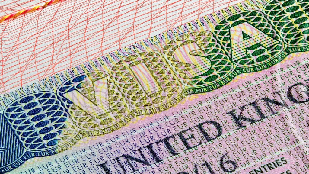 A United Kingdom visa stamp in a passport. (Photo: iStockphoto)
