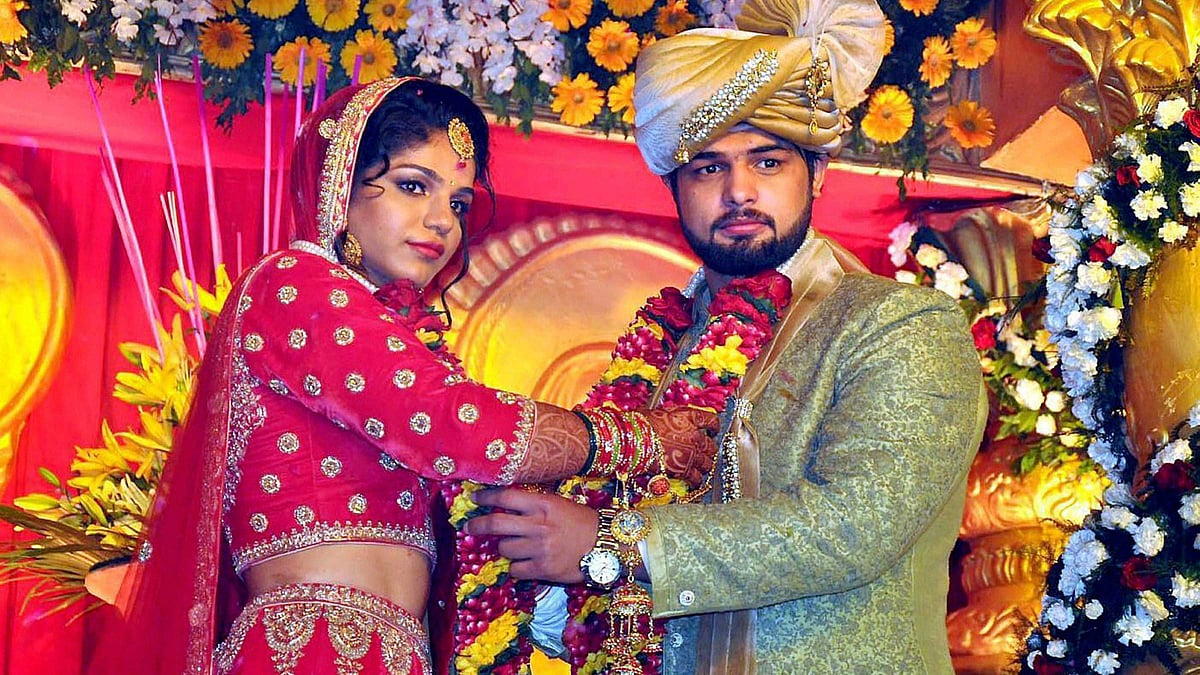Sakshi Malik with Satyawart Kadian during their wedding ceremony in Rohtak on Sunday. (Photo: PTI)