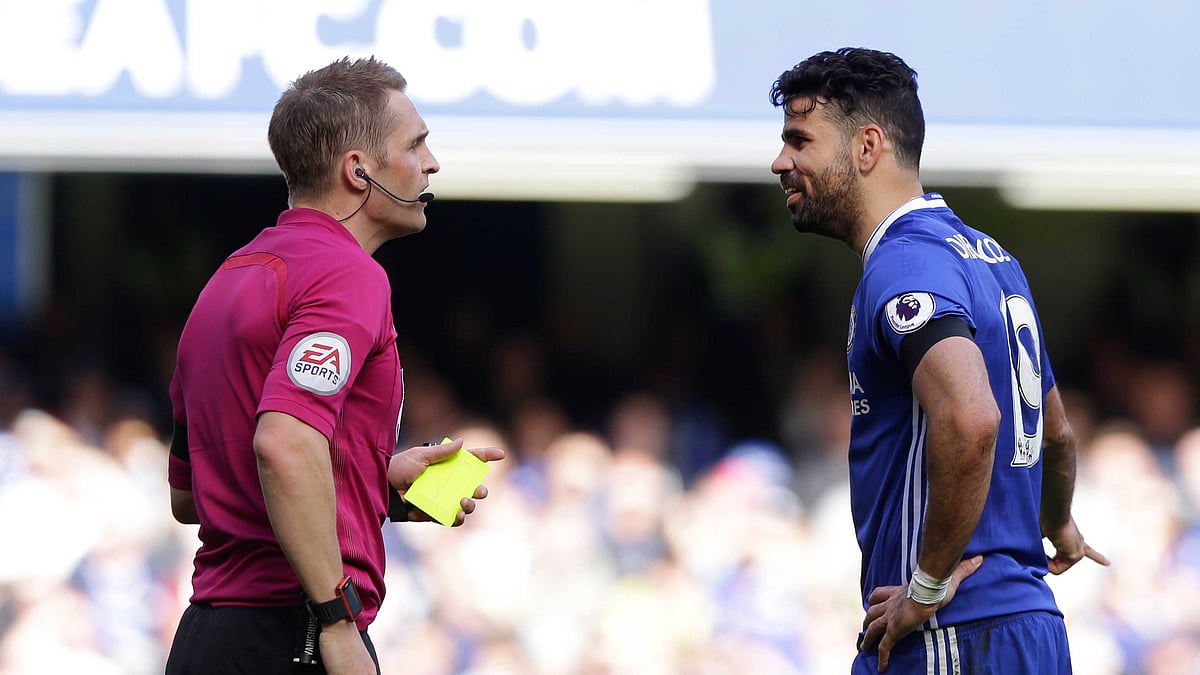 Referee Craig Pawson, left, shows a yellow card to Chelsea’s Diego Costa for a foul during their English Premier League match between Chelsea and Crystal Palace at Stamford Bridge. (Photo: AP)