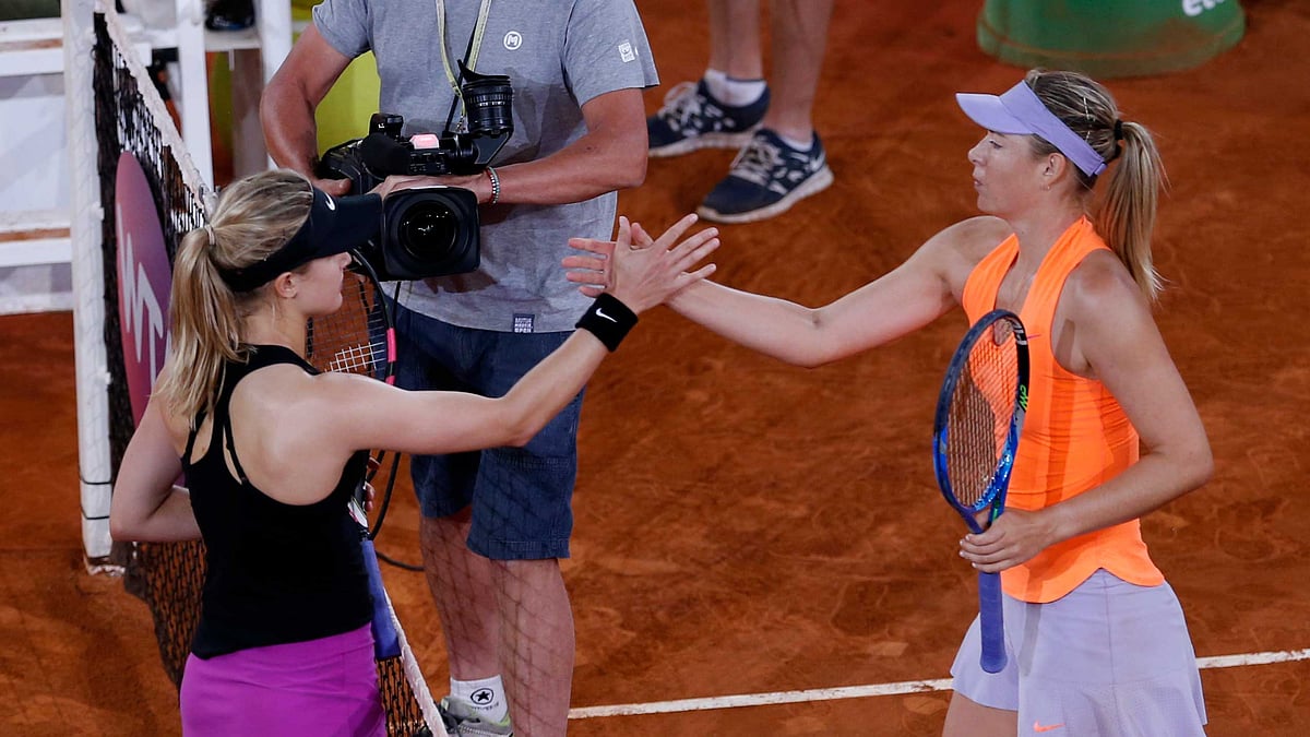 Eugenie Bouchard from Canada, left, shakes hands with Maria Sharapova from Russia at the end of their Madrid Open. (Photo: AP)