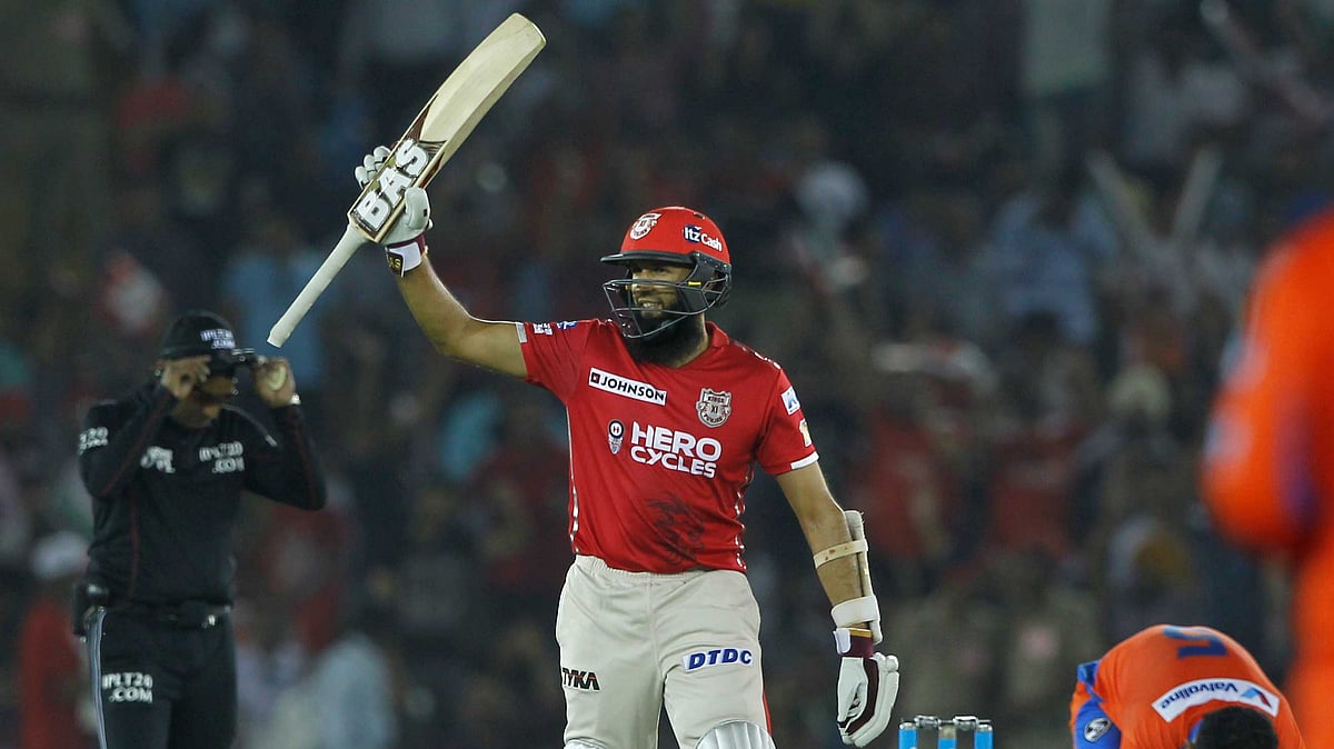 Hashim Amla raises his bat to celebrate his century. (Photo: BCCI)