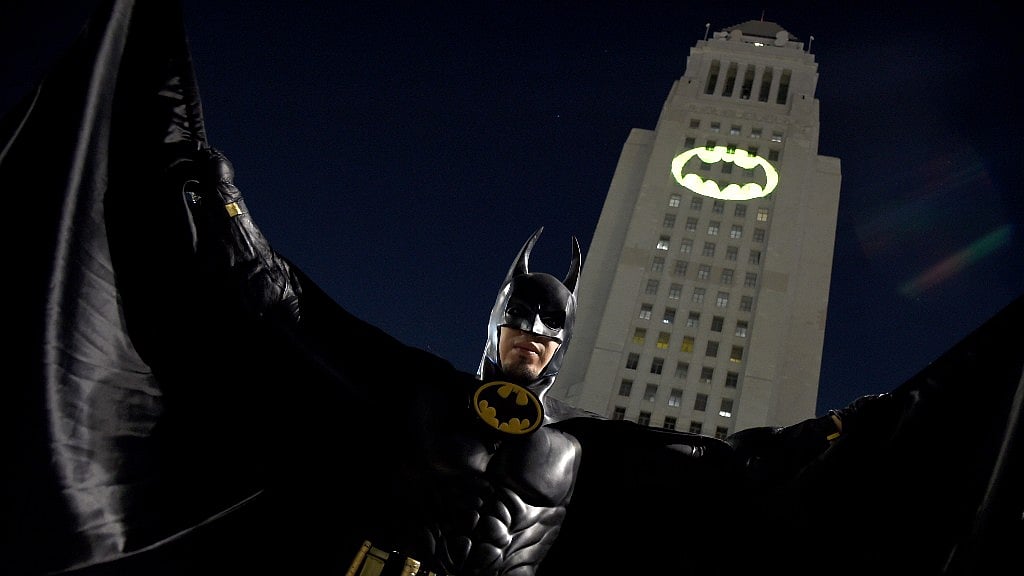 A man poses in front of a Bat-Signal projected onto City Hall at a tribute to “Batman” star Adam West on Thursday, June 15, 2017, in Los Angeles. (Photo: AP)