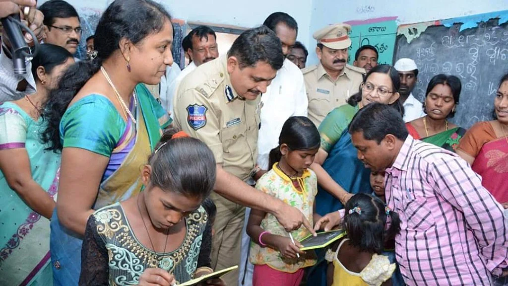 Police officer Mahesh Muralidhar Bhagwat interacting with children rescued from a brick kiln at Chikati Mamidi village of Telangana in January 2016.