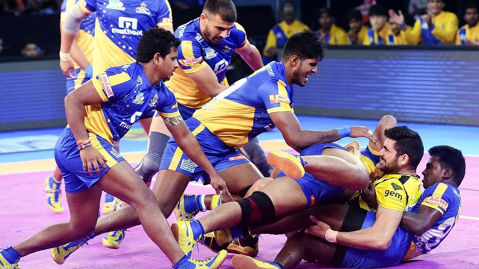 Telugu Titans and Tamil Thalaivas players in action.