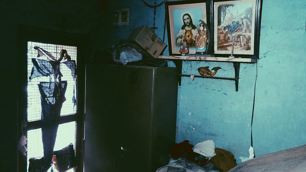 The living space is a mess – crowded with run-down furniture, a mattress, and household utensils