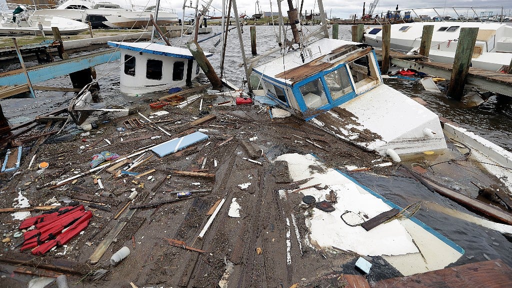 Boats that sunk in the wake of Hurricane Harvey are surrounded by floating debris Sunday, 27 August 2017, in Rockport, Texas.