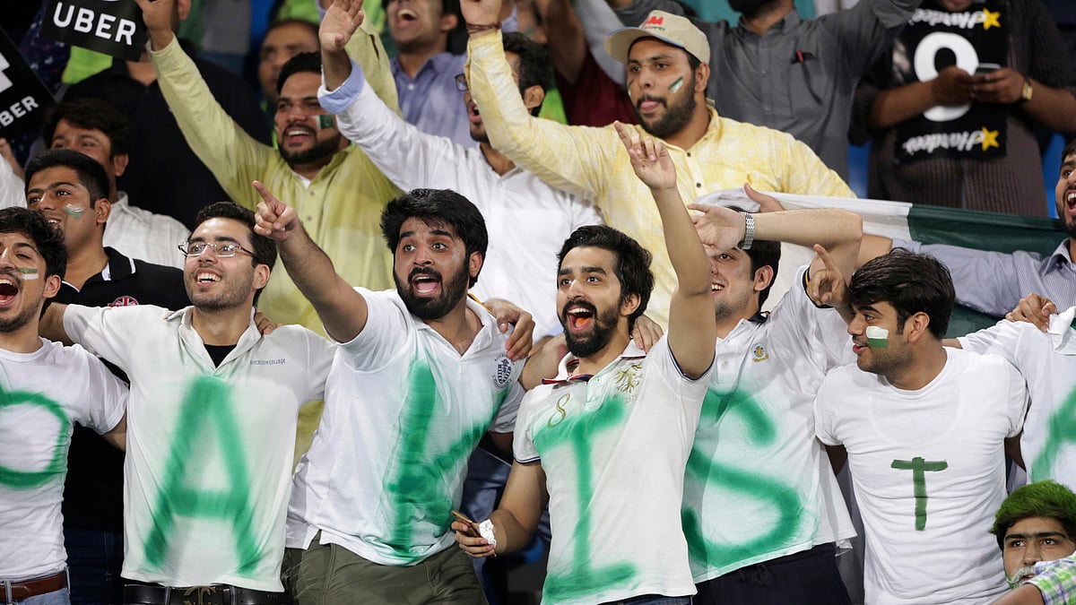Pakistani cricket fans watch a match between World XI and Pakistan at Gaddafi stadium, in Lahore, Pakistan