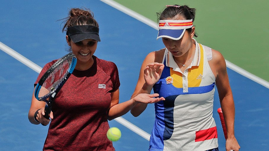 Sania Mirza slaps hands with doubles partner Peng Shuai during the doubles semifinals of the US Open.