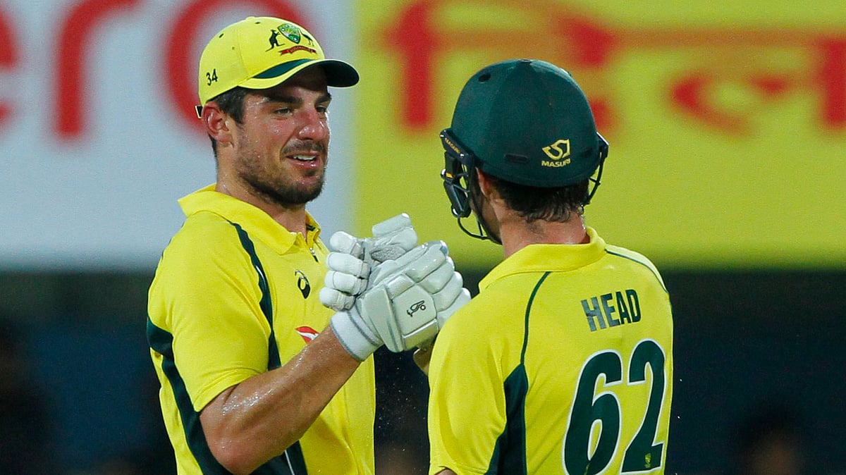 Moises Henriques celebrates with Travis Head after Australia beat India by 8 wickets.