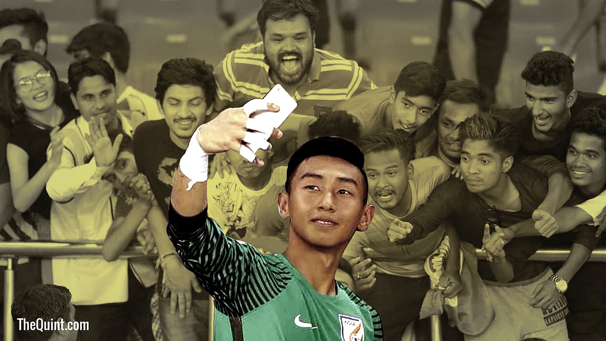 Indian keeper Dheeraj Singh takes a picture with fans after the match against Colombia.