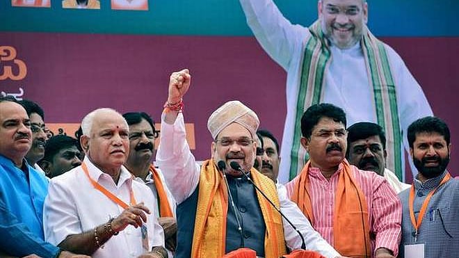 BJP president Amit Shah wearing a Mysore peta while addressing a gathering during his three-day visit to Karnataka.
