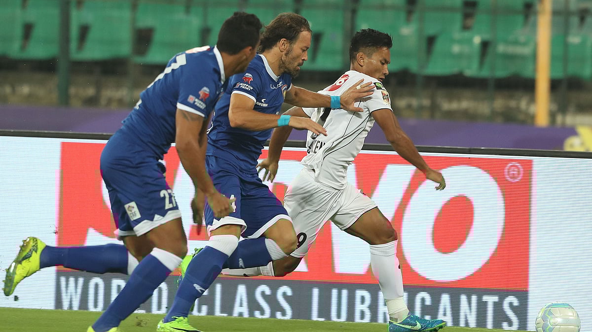 Inigo Calderon of Chennaiyin FC and Seiminlen Doungel of NorthEast United FC fight for the ball during an ISL match.