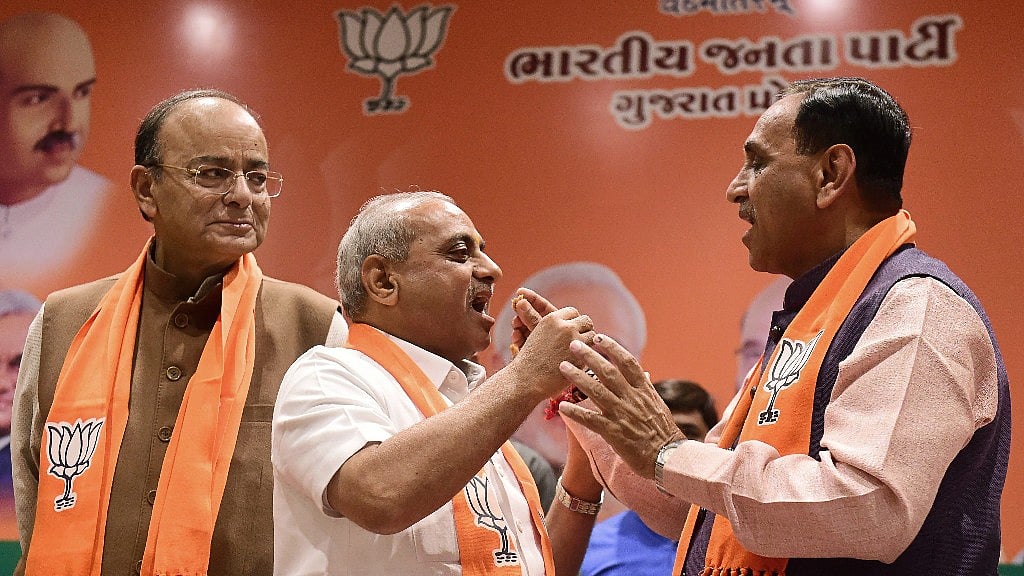 Finance Minister Arun Jaitley, Deputy CM of Gujarat Nitin Patel and CM Vijay Rupani.&nbsp;