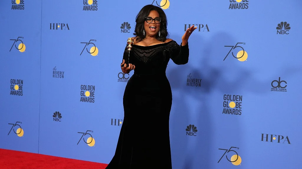 Oprah Winfrey poses backstage with her Cecil B. DeMille Award at the 75th Golden Globe Awards.