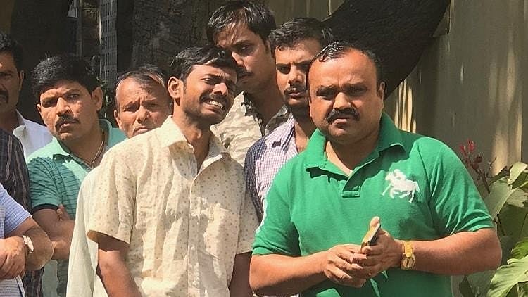 Family members of the five victims who died in the fire in Kailash Bar and Restaurant weep for their loved ones as they wait for the autopsies to be completed.